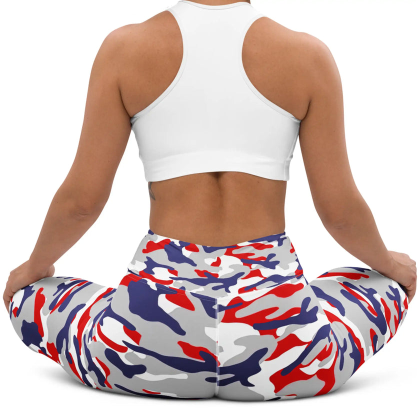 Woman sitting in original Buffalo football camouflage leggings, showing the flexible fitted style and striking red white blue and grey team-color print.