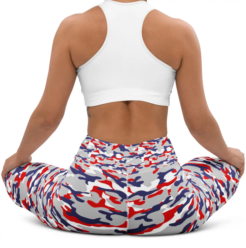 Woman sitting in original Nickel City Buffalo camouflage leggings, showing the flexible fitted style and striking red white blue and grey color print.
