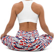 Woman sitting in original Nickel City Buffalo camouflage leggings, showing the flexible fitted style and striking red white blue and grey color print.