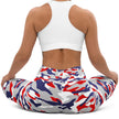 Woman sitting in original Buffalo football camouflage leggings, showing the flexible fitted style and striking red white blue and grey team-color print.