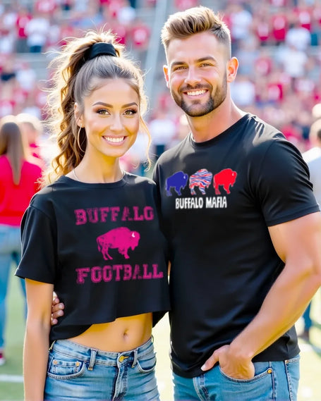 Male and female couple posing together at Buffalo football stadium while wearing matching black Buffalo football shirts, showcasing modern Buffalo game day apparel.