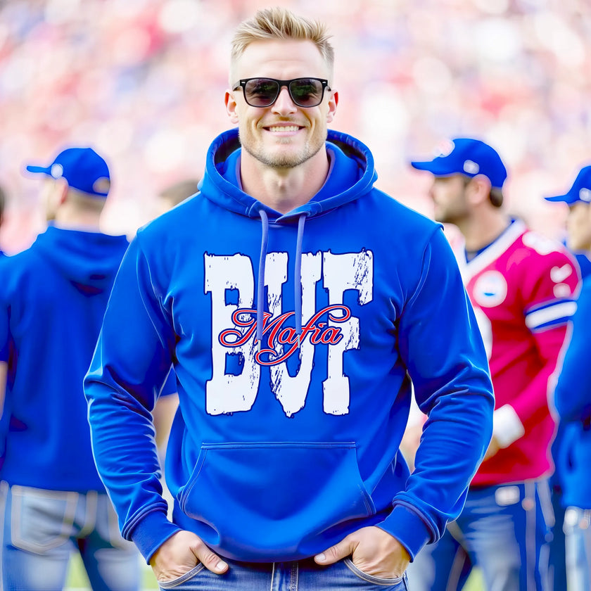 Male model wearing blue Buffalo football streetwear hoodie standing on the field at a Buffalo football game