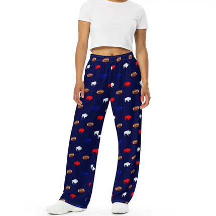 Front view of navy Buffalo football pajama pants with wide leg fit and repeating red white blue buffalo silhouettes paired with brown footballs.
