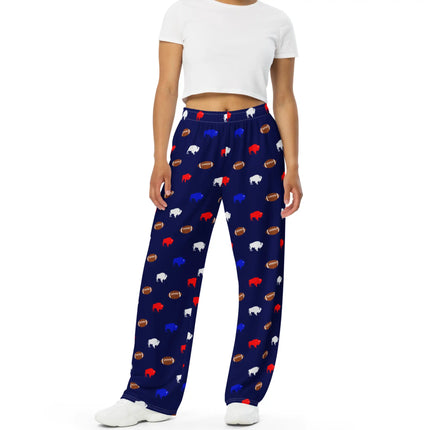 Front view of navy Buffalo football pajama pants with wide leg fit and repeating red white blue buffalo silhouettes paired with brown footballs.