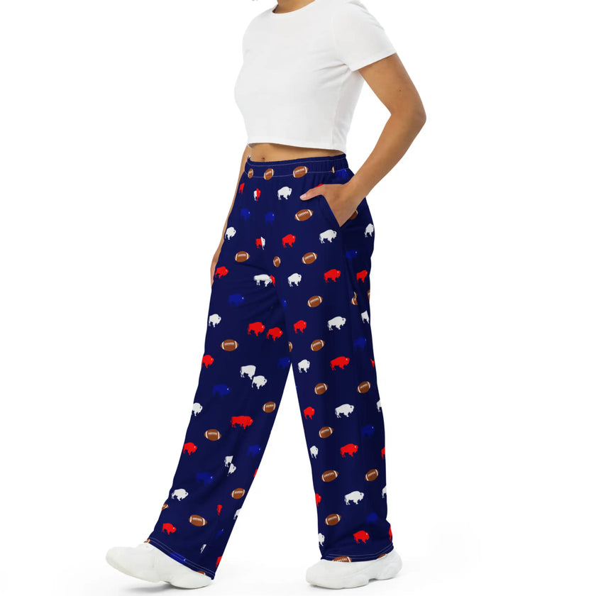 Side view of navy Buffalo football lounge pants showcasing repeating red white and blue buffalo silhouettes with brown football pattern on lightweight relaxed sleepwear.