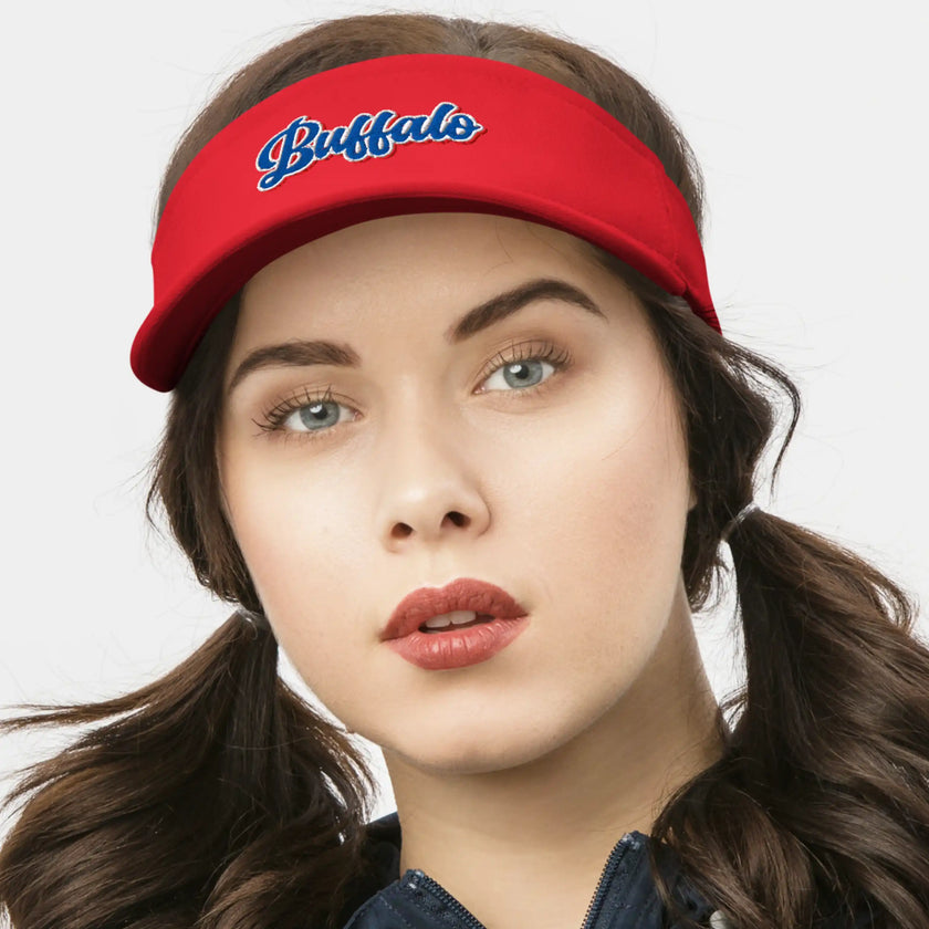 Woman wearing a red Buffalo golf visor featuring retro red white and blue embroidered lettering, sporty and stylish headwear for golf and outdoor days.