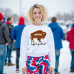 Woman wearing a white Buffalo football sweatshirt featuring a brown buffalo football graphic with laces and black scroll lettering, showing off a cute football-inspired fan look.