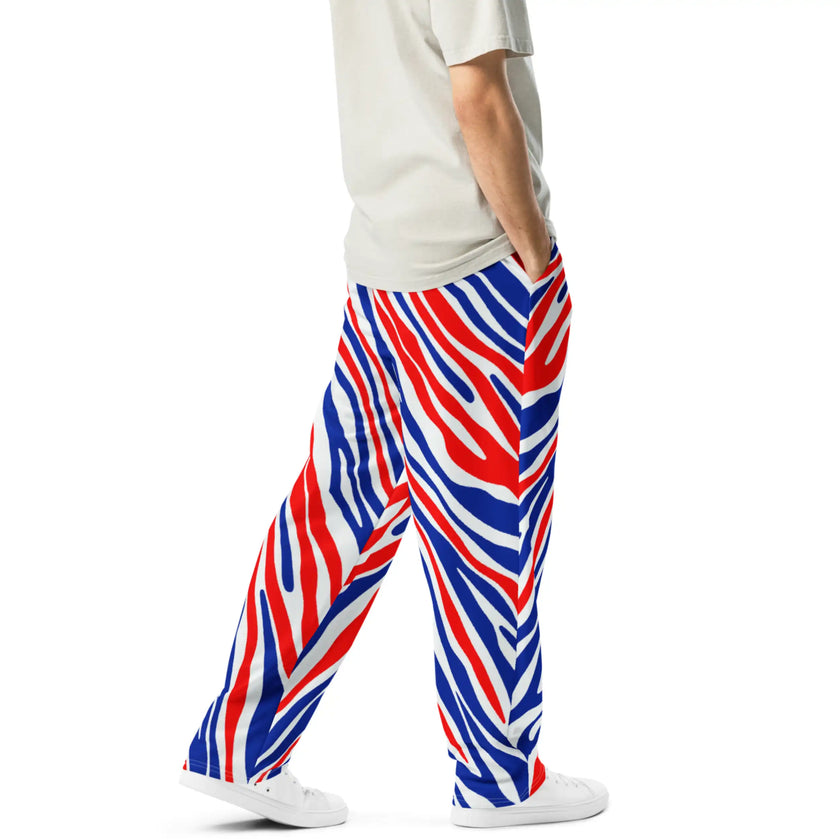 Right side view of man wearing premium Buffalo football joggers featuring signature red white and blue stripe pattern, bold statement pants for Buffalo supporters.