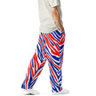 Right side view of man wearing premium Buffalo football joggers featuring signature red white and blue stripe pattern, bold statement pants for Buffalo supporters.