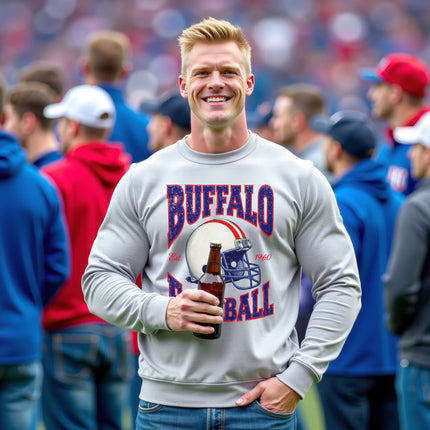 Male model wearing light gray Buffalo Football 90s retro helmet sweatshirt standing on football field drinking beer
