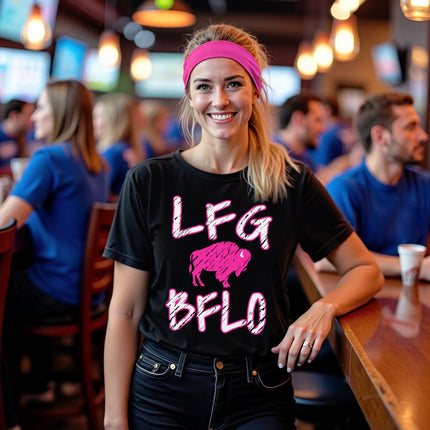 Female model wearing black women’s Buffalo football LFG BFLO graphic t-shirt with distressed hot pink lettering and buffalo silhouette design, game day tailgate lifestyle apparel.