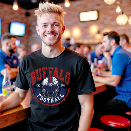 Male wearing black vintage Buffalo football t-shirt with white helmet and retro graphic, sitting at the bar, casual fan style.