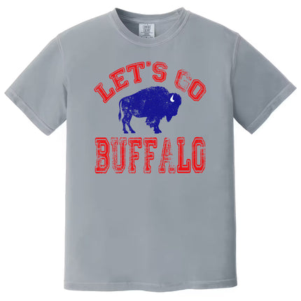Gray Let’s Go Buffalo football tee with red distressed text and blue buffalo graphic, flat lay on white background.