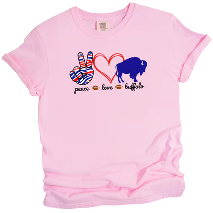 Pink Peace Love Buffalo t-shirt with playful graphics, red heart, and blue buffalo, flat lay on white background.