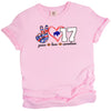 Pink Peace Love 17 Buffalo quarterback football shirt with striped peace sign, red heart, and white number design, flat lay on white background.