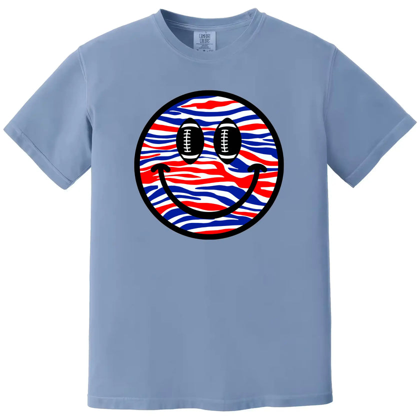 Football smiling face t-shirt in light blue, red white blue striped pattern with football eyes, Buffalo fan game day graphic tee.