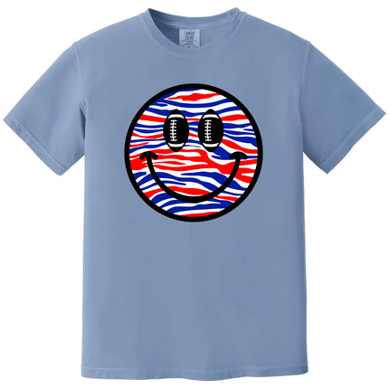 Football smiling face t-shirt in light blue, red white blue striped pattern with football eyes, Buffalo fan game day graphic tee.