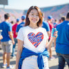 Woman wearing white Buffalo football t-shirt with striped heart graphic, standing on football field showing team pride.