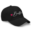 Black classic dad hat right front angle showing Buffalo script embroidery with hot pink hearts on dad hat design.