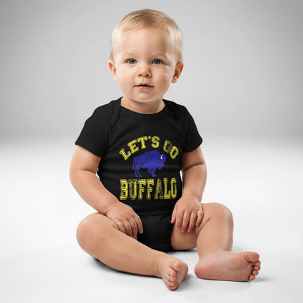 Baby wearing black Buffalo hockey ‘Let’s Go Buffalo’ bodysuit with distressed yellow lettering and blue buffalo silhouette graphic, front view.