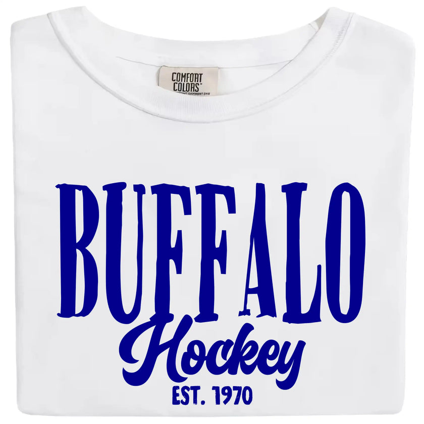White Buffalo Hockey Est. 1970 t-shirt featuring striking blue vintage-style lettering, clean classic apparel for proud Buffalo hockey fans.