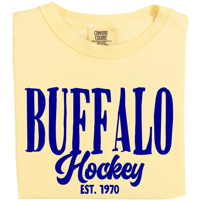 Yellow Buffalo Hockey Est. 1970 graphic tee with bold blue retro lettering, classic fan apparel honoring Buffalo's hockey heritage since 1970