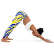 Woman stretching while wearing Buffalo hockey leggings with vibrant blue and gold stripes, demonstrating the comfortable flexible fit for active movement.