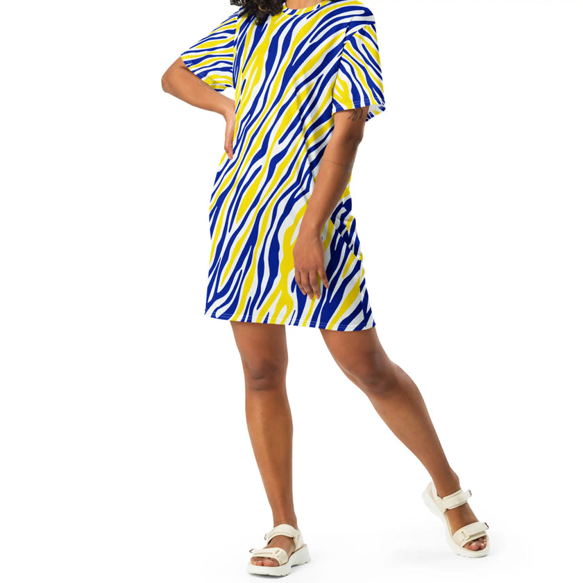 Woman posing in an oversized Buffalo hockey t-shirt dress featuring the signature blue and gold Buffalo stripe pattern, expressive fan fashion with a standout original look.
