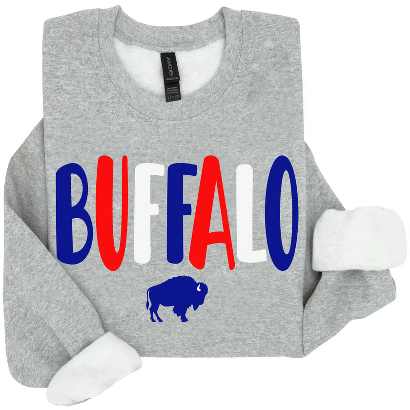 Grey Buffalo NY sweatshirt featuring colorful red white and blue Buffalo lettering with a small buffalo silhouette, casual hometown pride clothing.