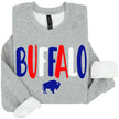 Grey Buffalo NY sweatshirt featuring colorful red white and blue Buffalo lettering with a small buffalo silhouette, casual hometown pride clothing.