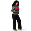 Woman posing in green camouflage heavyweight hoodie with large hot pink buffalo silhouette, stylish Buffalo game day hoodie for women with bold hometown pride.