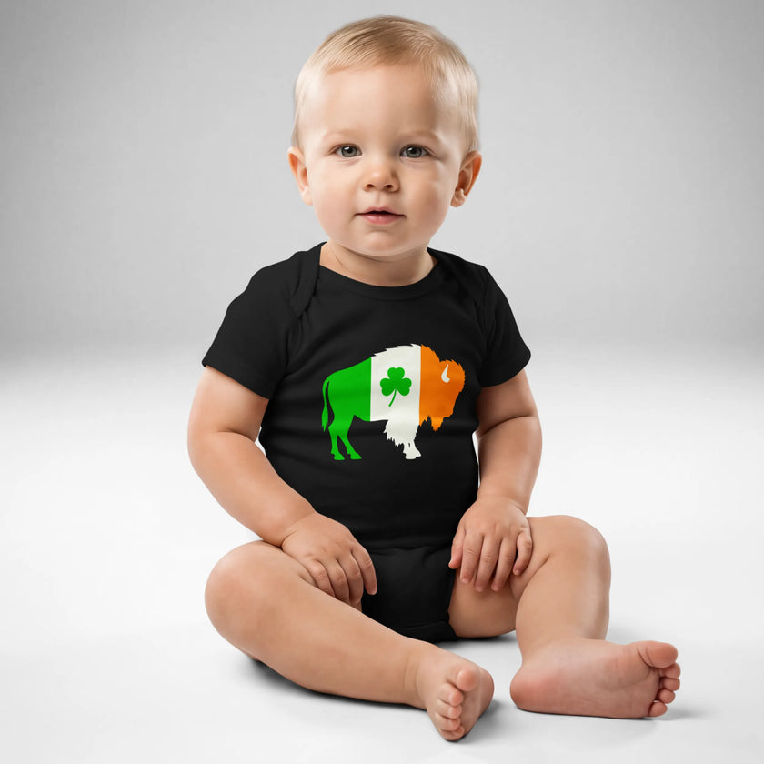 Baby wearing black Buffalo Irish baby bodysuit featuring Irish flag colored buffalo silhouette and shamrock design, front view Irish heritage baby outfit.