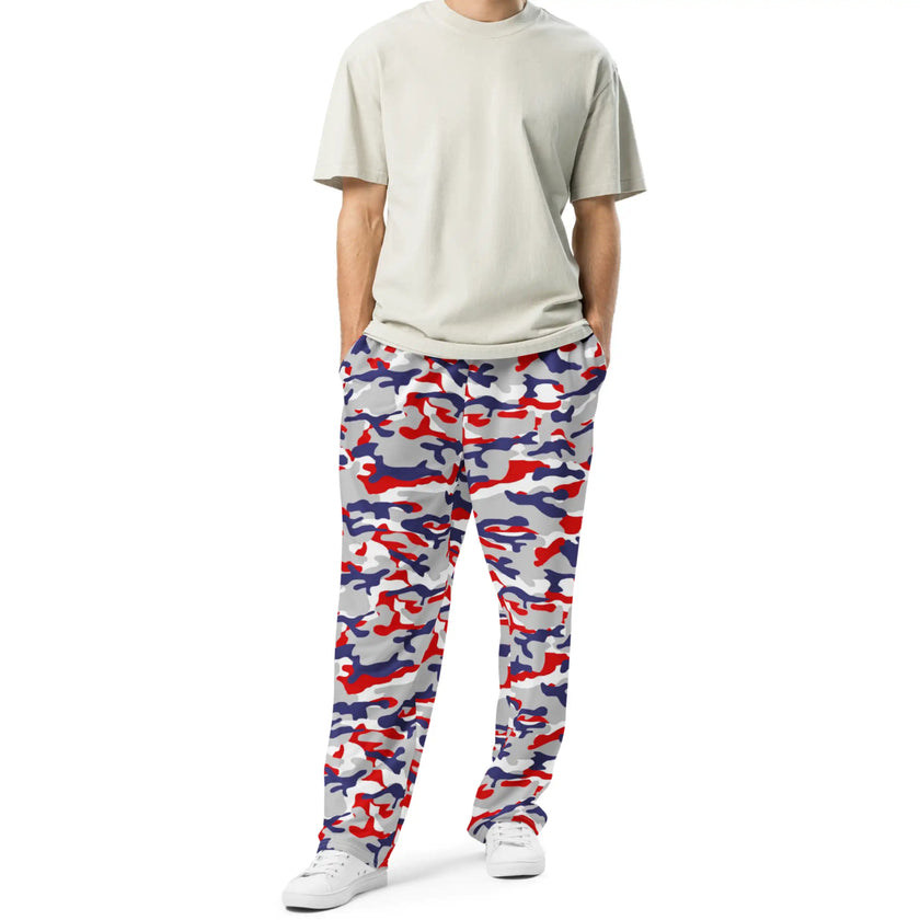 Man wearing Nickel City Buffalo camouflage joggers featuring a red blue and grey team-color inspired pattern, stylish casual apparel for game day, lounging, or errands.