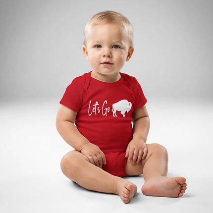 Baby wearing red Buffalo sports baby bodysuit featuring ‘Let’s Go’ script lettering and buffalo silhouette graphic, front view cheer outfit.