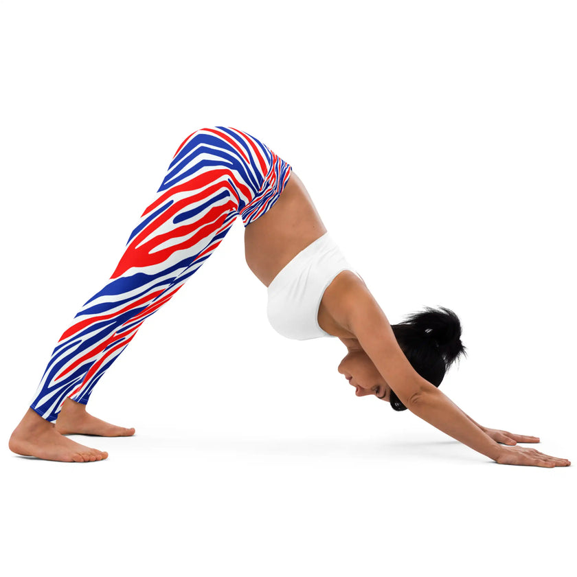 Woman in yoga pose wearing Buffalo stripes leggings with signature red white and blue Buffalo football stripe pattern, flexible athletic leggings for movement and style.