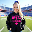 Female model wearing black Buffalo football hoodie featuring hot pink ‘Buffalo vs. Everybody’ lettering with matching buffalo silhouette, bold Buffalo football fan style.