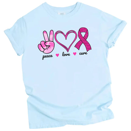 Blue “Peace, Love, Cure” t-shirt flat lay featuring pink icons and positive cause message for breast cancer support and everyday wear