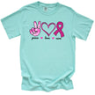 Mint “Peace, Love, Cure” t-shirt flat lay with pink tie-dye hand, double-heart, and glittery ribbon icons for awareness and advocacy