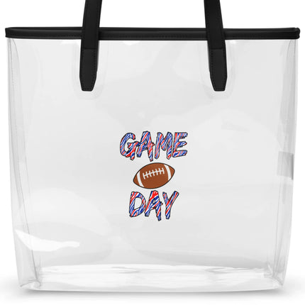 Close-up of clear TPU Game Day stadium tote bag featuring brown football design and bold red white and blue striped lettering on transparent durable material.