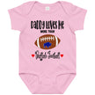 Pink baby bodysuit showcasing a cute Buffalo football graphic with ‘Daddy Loves Me More Than Buffalo Football’ wording, surrounded by charming hearts for a playful baby fan look.