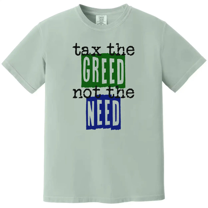 Green “Tax the Greed, Not the Need” t-shirt flat lay featuring bold letters and minimalist design for people-first advocacy