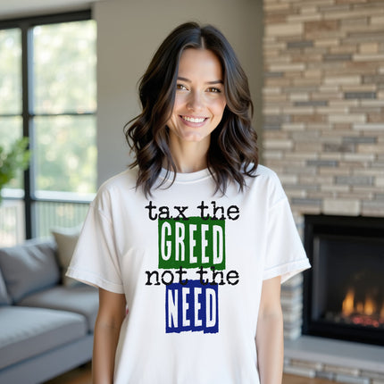 Model wearing white “Tax the Greed, Not the Need” t-shirt in a casual living room setting, confidently showing social justice and people-first values