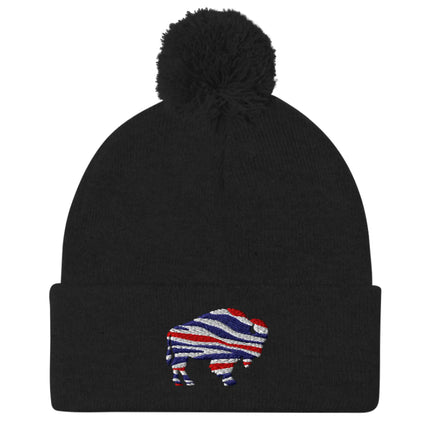 Black puffball pom pom beanie featuring embroidered Buffalo silhouette with red white blue football team color stripes, warm Buffalo winter hat.
