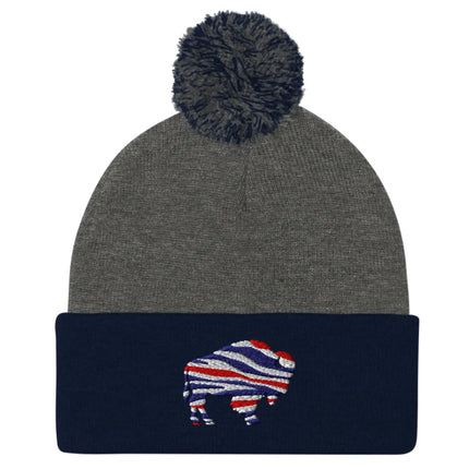 Two-tone navy and grey pom pom beanie with embroidered Buffalo silhouette in red white blue football team color stripes.