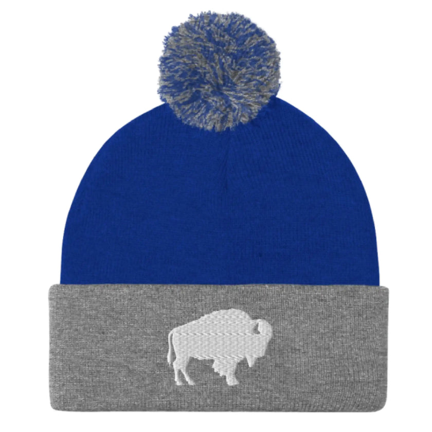 Blue and grey pom pom beanie winter hat with embroidered Buffalo silhouette logo, modern Buffalo inspired winter accessory.