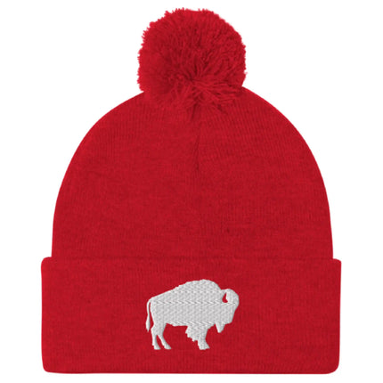 Red pom pom beanie featuring embroidered Buffalo silhouette logo, bold winter hat inspired by Buffalo city and sports culture.