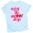 Summer strawberry tee in blue, ‘Enjoy the Sweet Days’ distressed retro font with strawberry letter detail, cute graphic shirt.