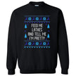 Black Hanukkah ugly sweater style sweatshirt featuring ‘Feed Me Latkes and Tell Me I’m Pretty’ in knitted-look font with festive reindeer and snowflake holiday design, cozy winter apparel.