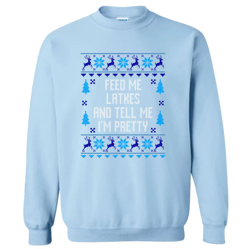 Light blue Hanukkah sweatshirt with ‘Feed Me Latkes and Tell Me I’m Pretty’ ugly sweater inspired design, knitted-look font with reindeer and snowflakes for cozy holiday apparel.