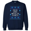 Navy blue Hanukkah sweatshirt with ‘Feed Me Latkes and Tell Me I’m Pretty’ ugly sweater style lettering, knitted font design with reindeer and snowflakes for cute festive holiday wear.